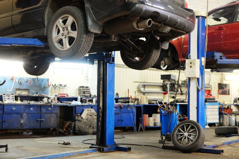 Quincy air compressor, small portable unit in an automotive shop with car lifts